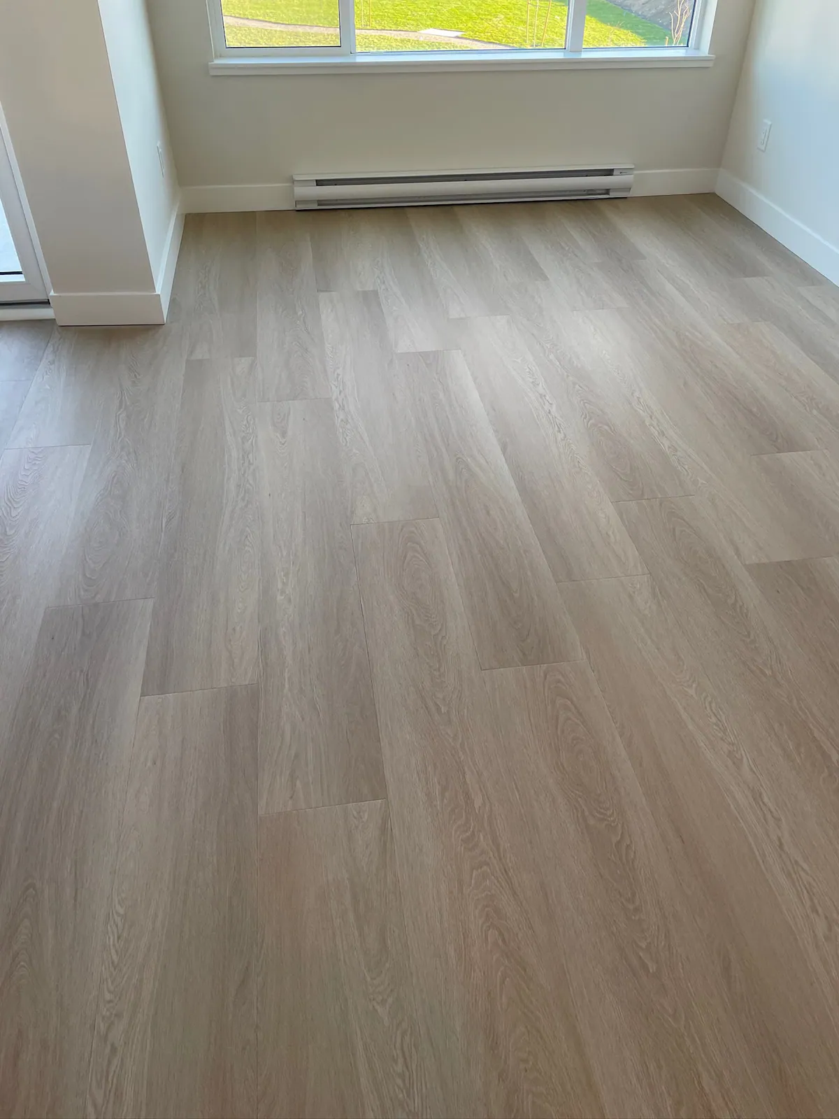 Open-plan hardwood flooring in a bright space — installed by Becker Flooring in Summerland